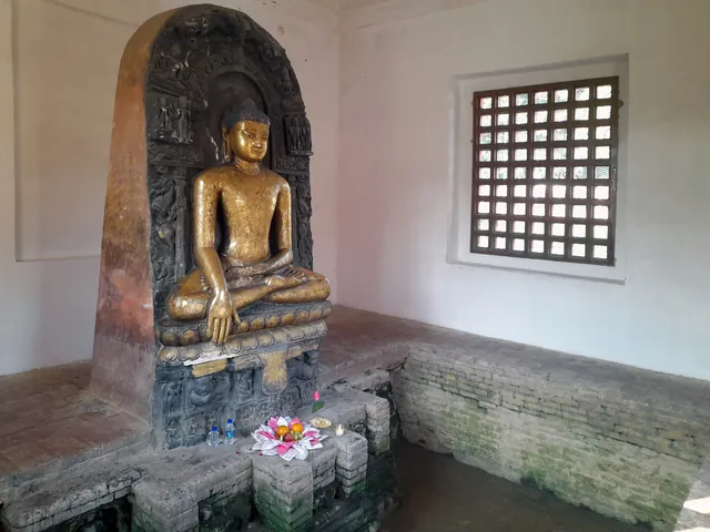 Seated Buddha statue in earth-touching gesture at Mathakuar Shrine, Kushinagar